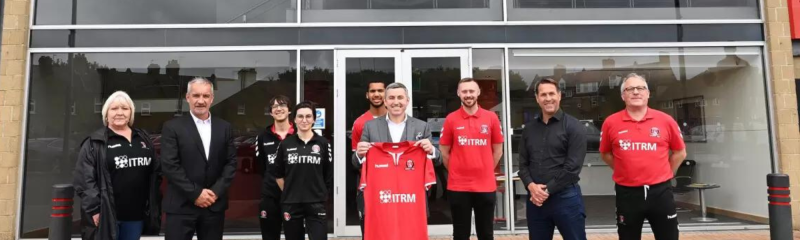 ITRM and Charlton Athletic Community Trust team outside The Valley, CAFC stadium holding a CAFC football top 