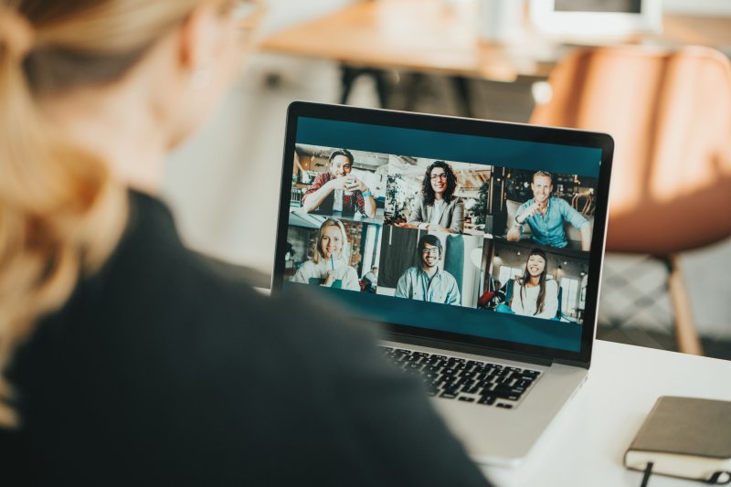 Laptop screen showing a video conference with six participants, highlighting remote collaboration and modern communication tools.