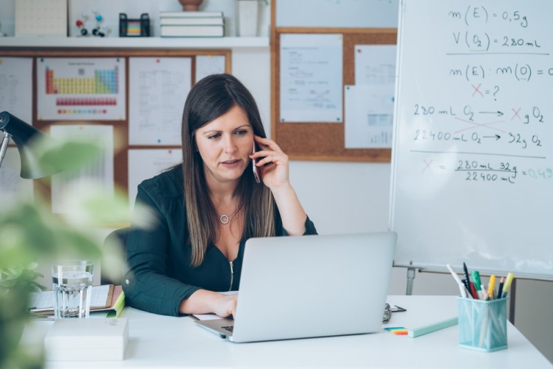 Teacher on the phone whilst on laptop